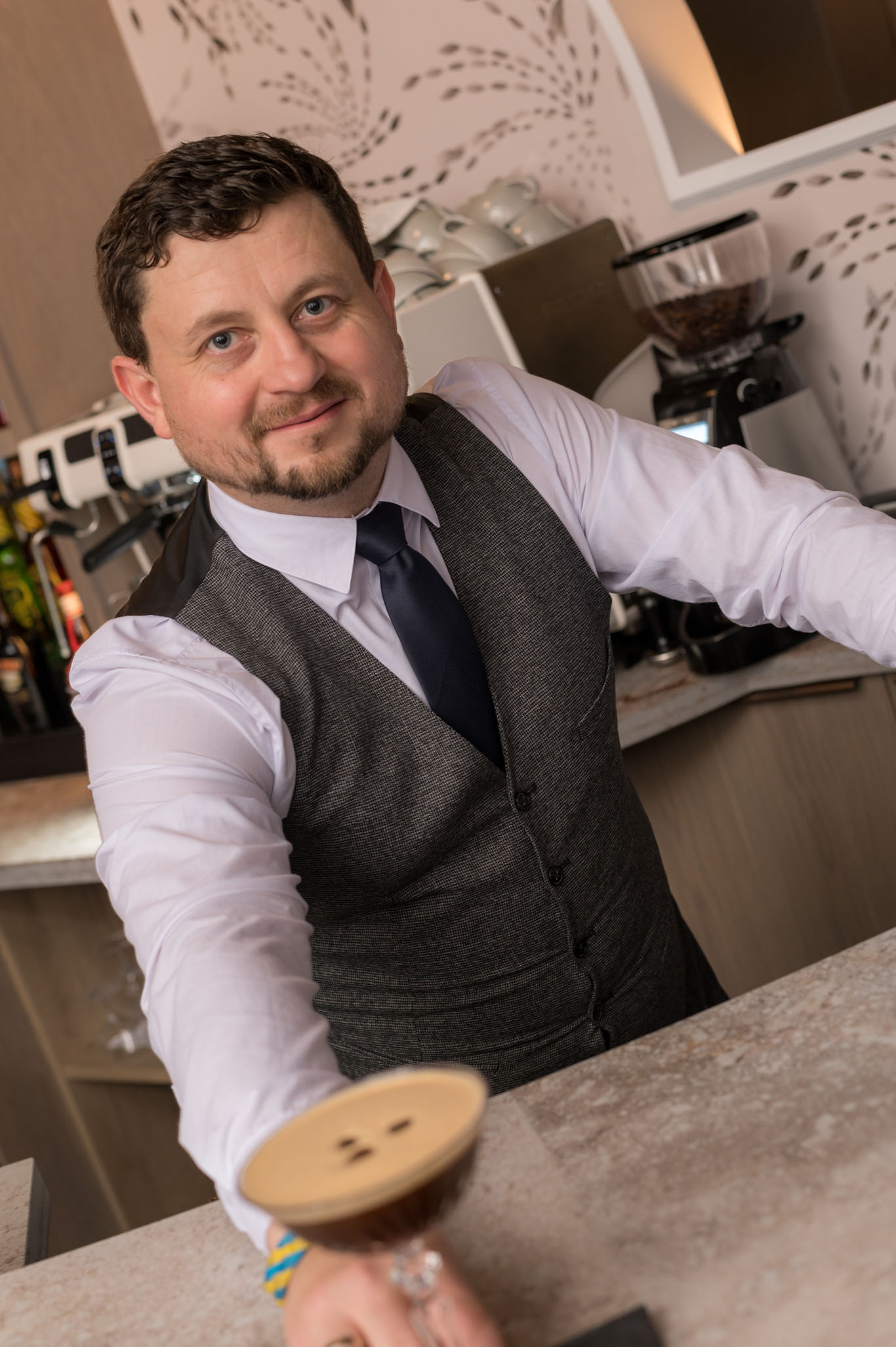 Oleks presenting a cocktail